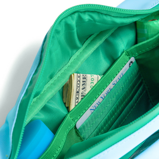 Interior of Springland fanny pack showing green-lined zippered pocket with cash inside