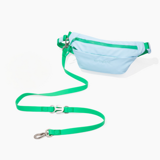 Light blue fanny pack walking bag with green leash attached, laid flat on white background